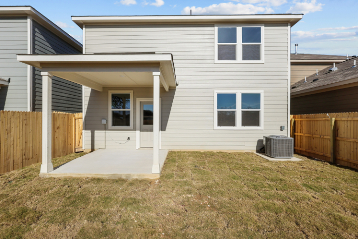 A house with a fence and grass.