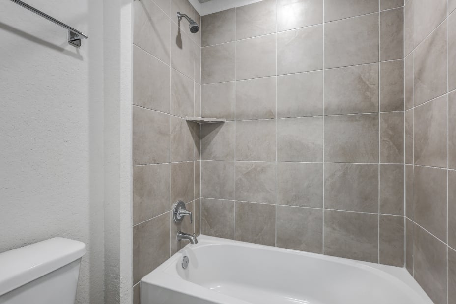 A bathroom with a bathtub and toilet.