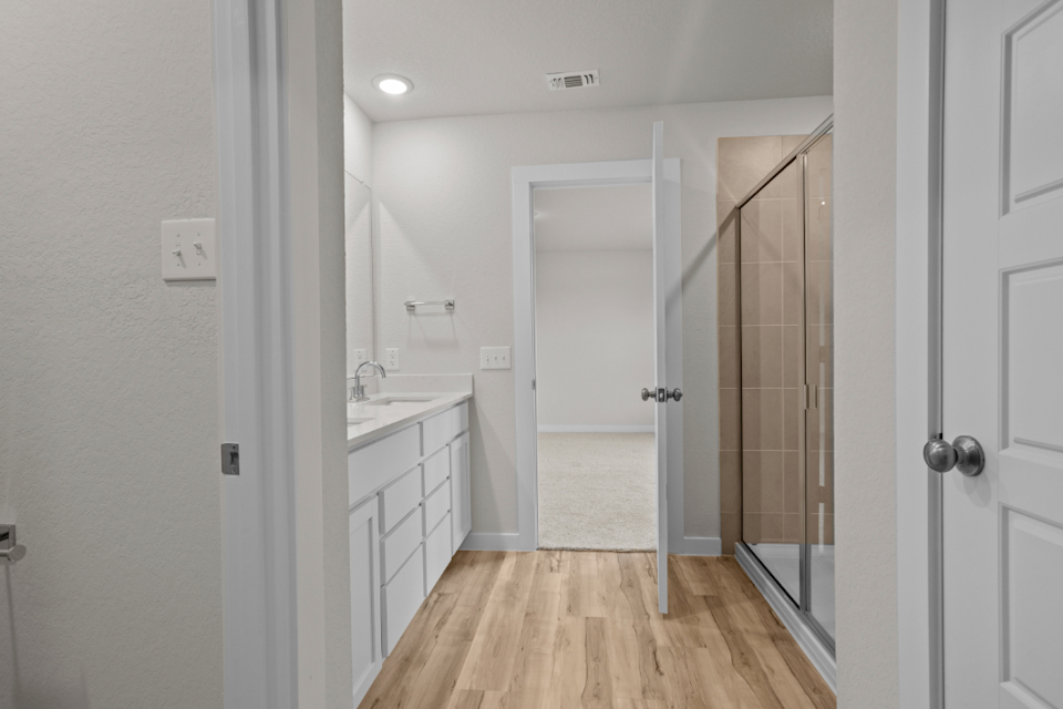 A bathroom with a shower and a sink.