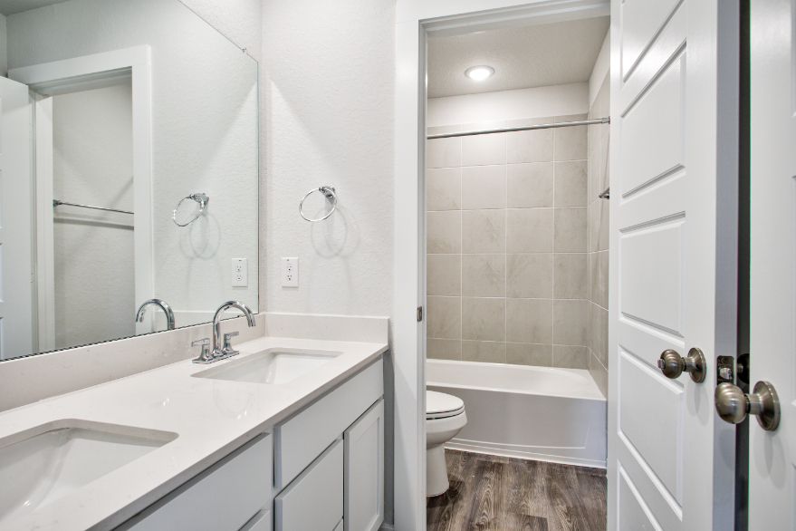 A bathroom with a sink toilet and bathtub.