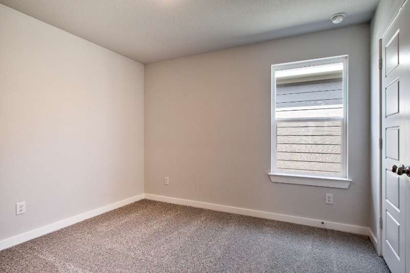A room with a door and a window.