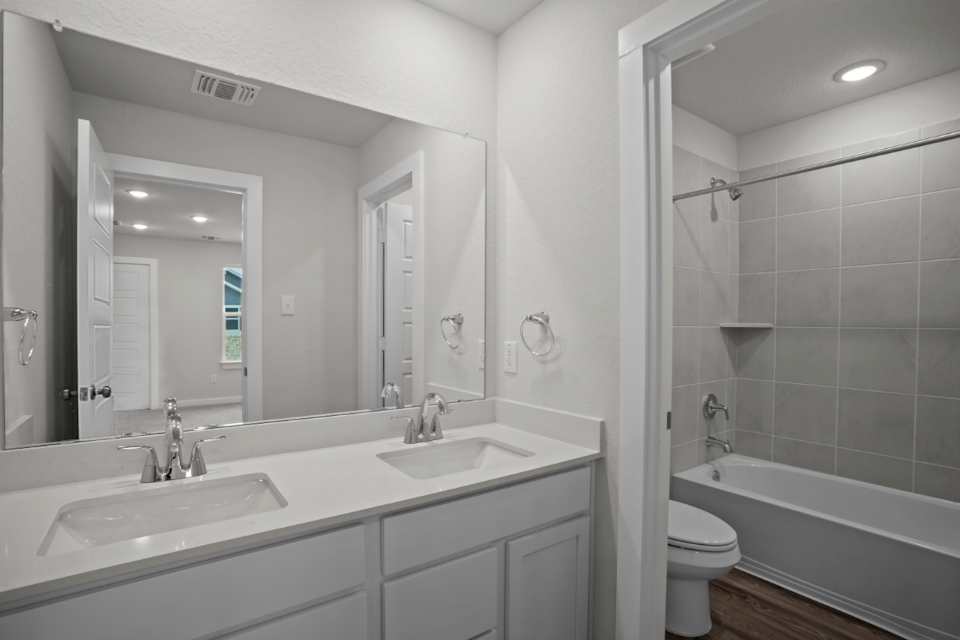 A bathroom with a tub sink and toilet.