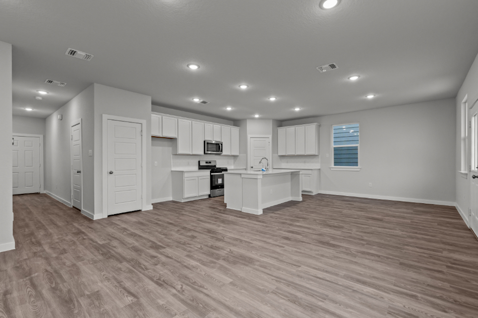 A large kitchen with white cabinets.