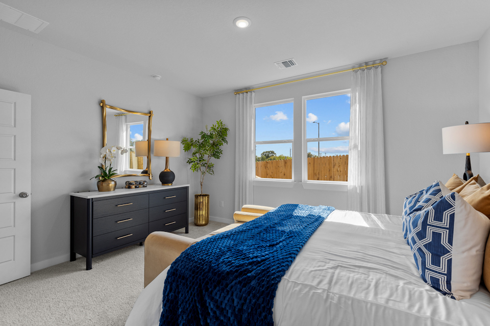 A bedroom with a bed and a window.