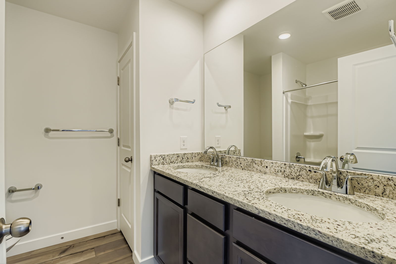 A bathroom with a large mirror.