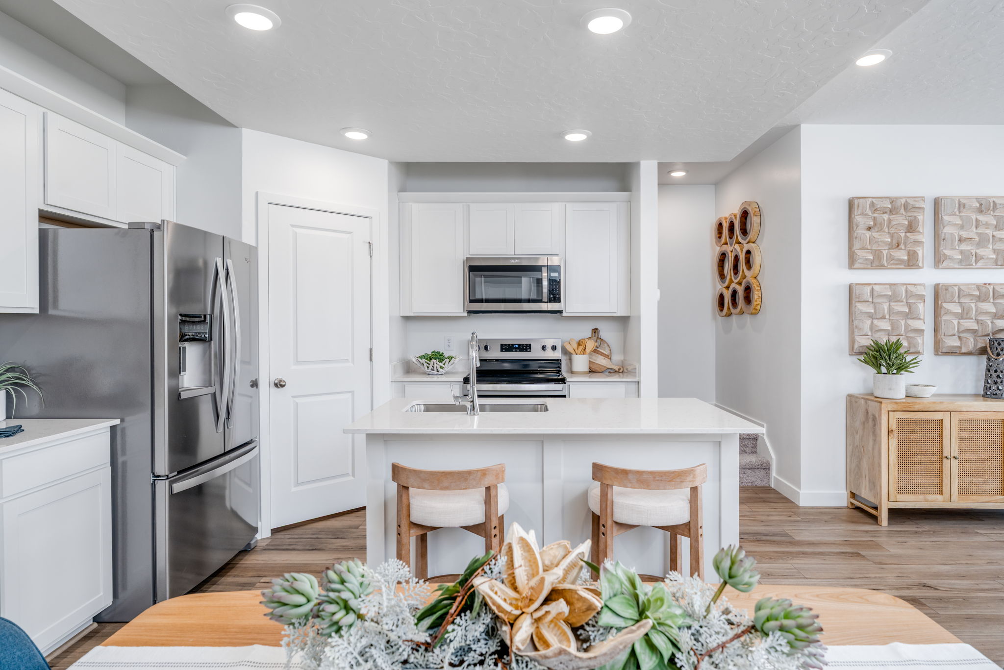 A kitchen with white cabinets.