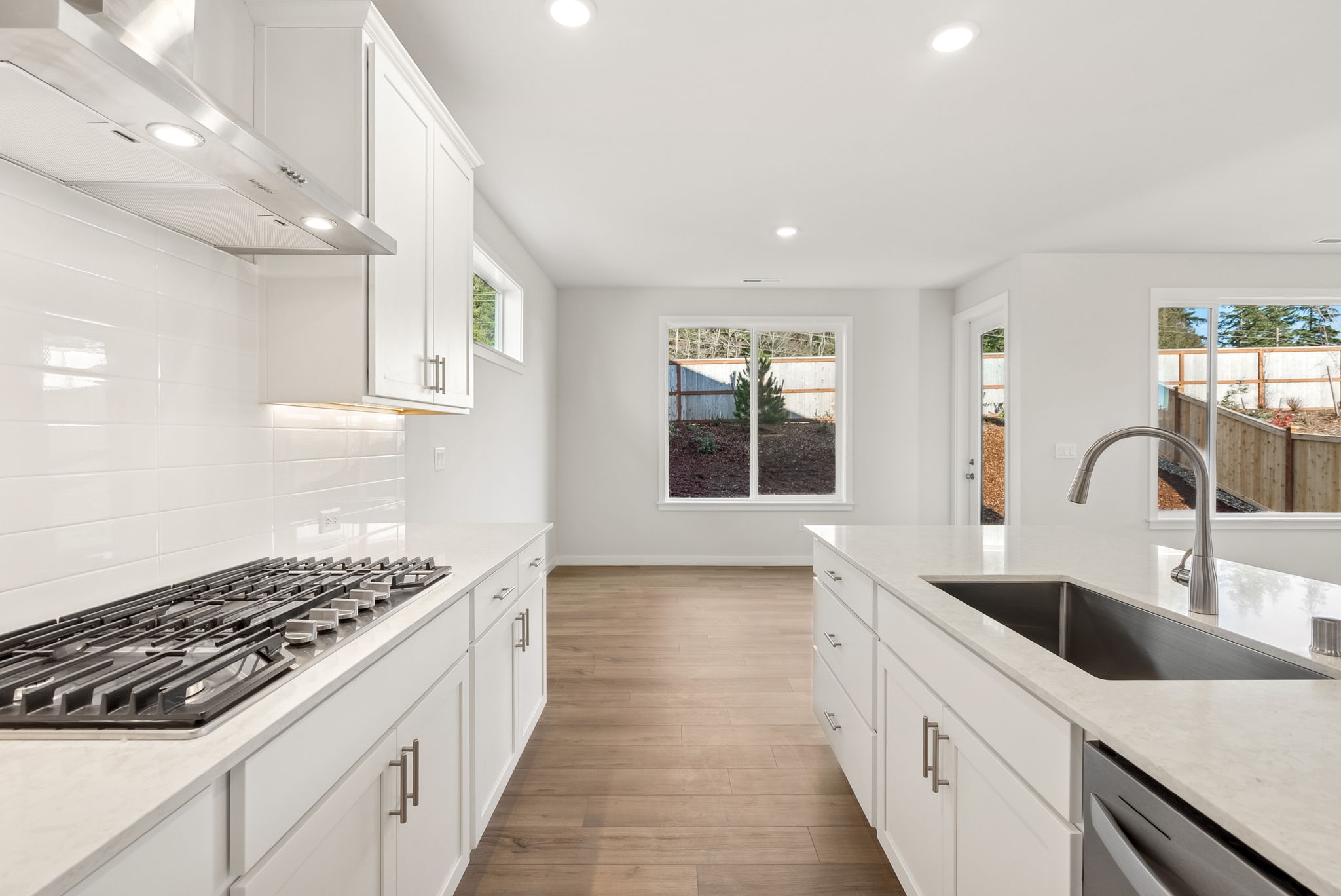 A kitchen with white cabinets.