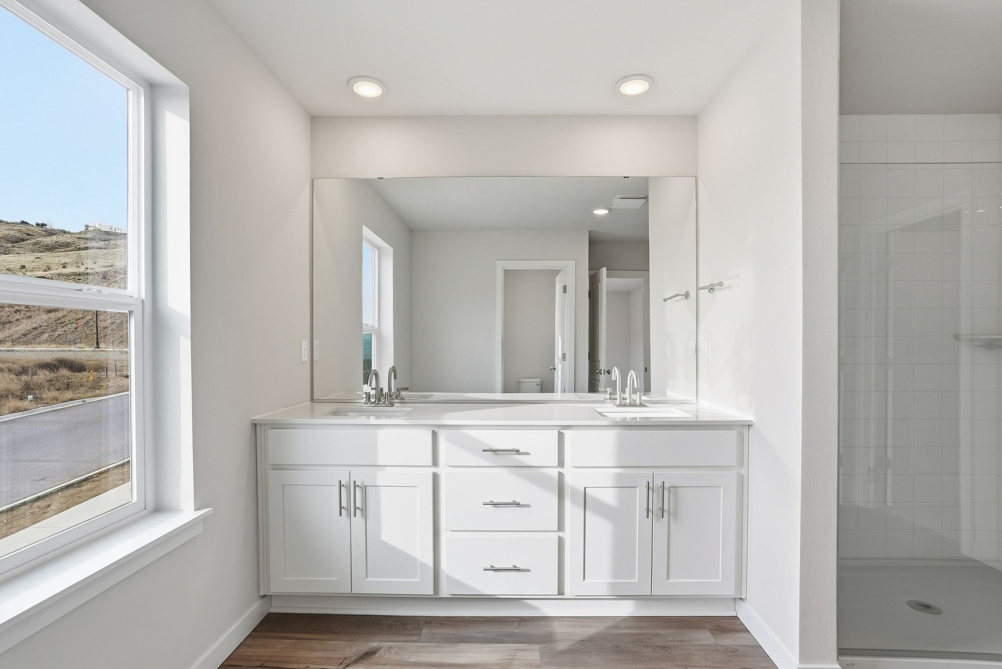 A bathroom with white cabinets.