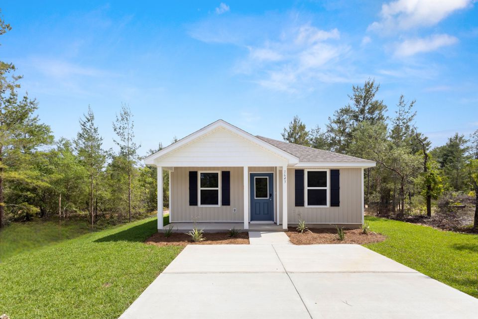 A house with a garage and grass.