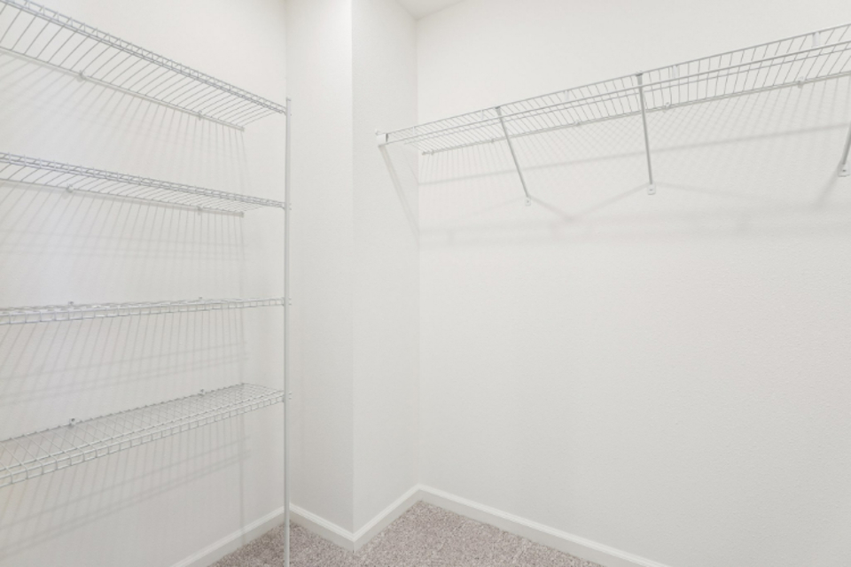 A white room with a metal railing.