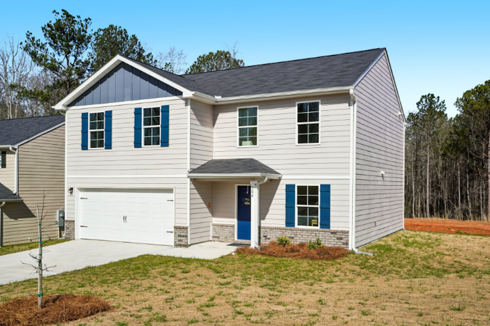 A white house with blue shutters.