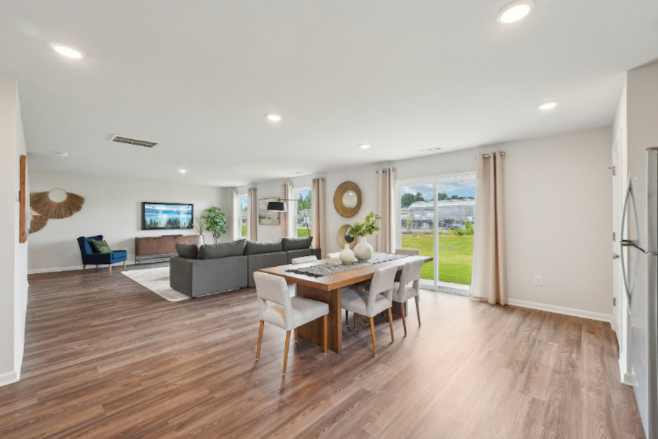 A large living room with a wood floor.