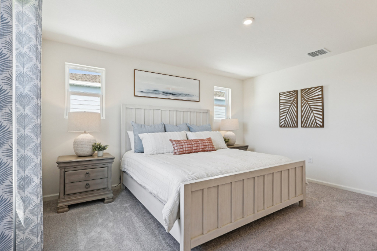 A bedroom with a bed and a dresser.