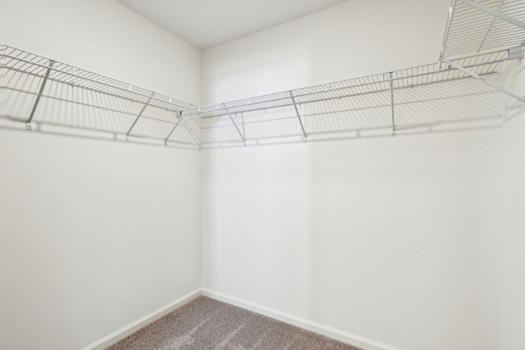 A white wall with a metal railing.