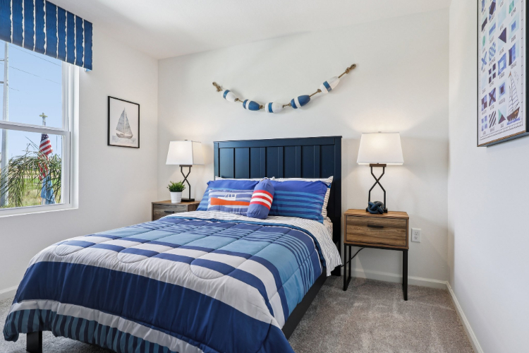 A bedroom with a bed and lamps.