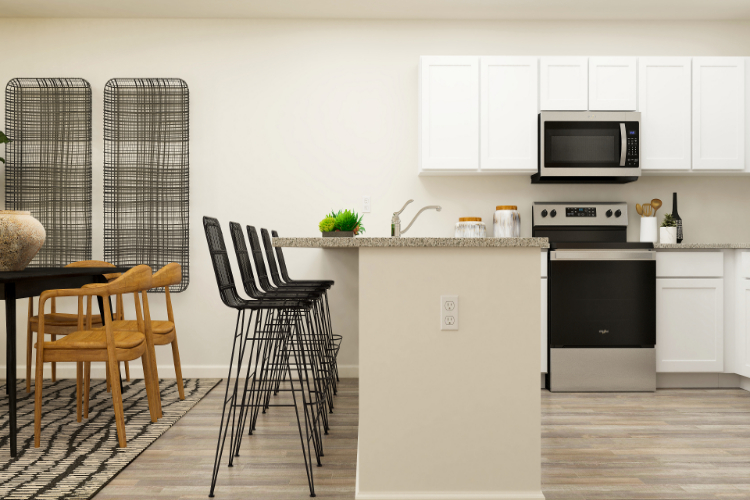 A kitchen with a table and chairs.