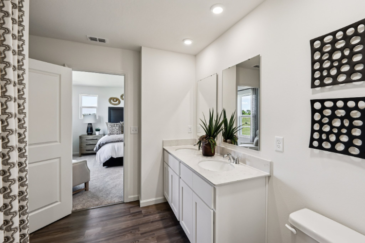 A bathroom with a bed and sink.