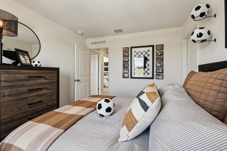 A room with a bed and a pillow with a panda face on it.