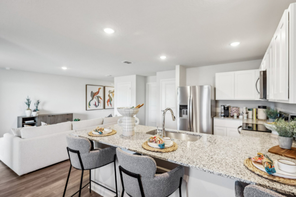 A kitchen with a marble counter top.