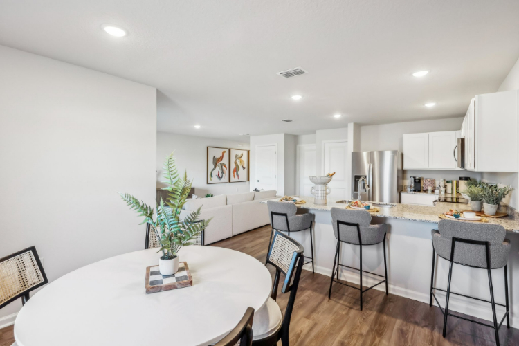 A kitchen with a dining table and a large island.