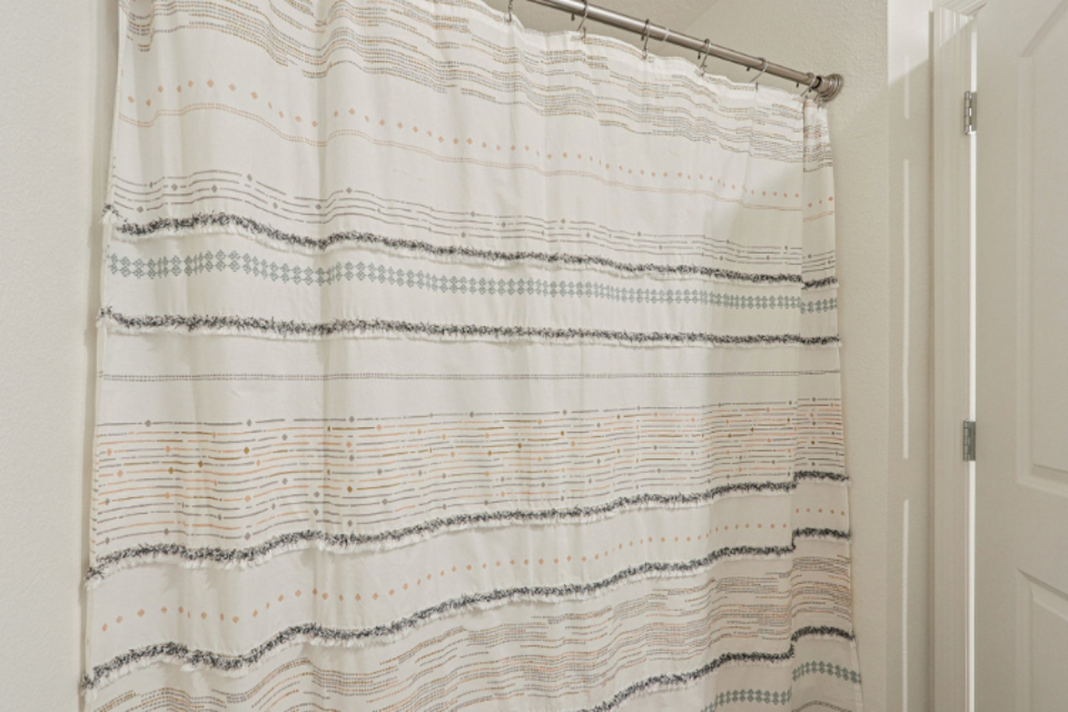 A white and black striped curtain.