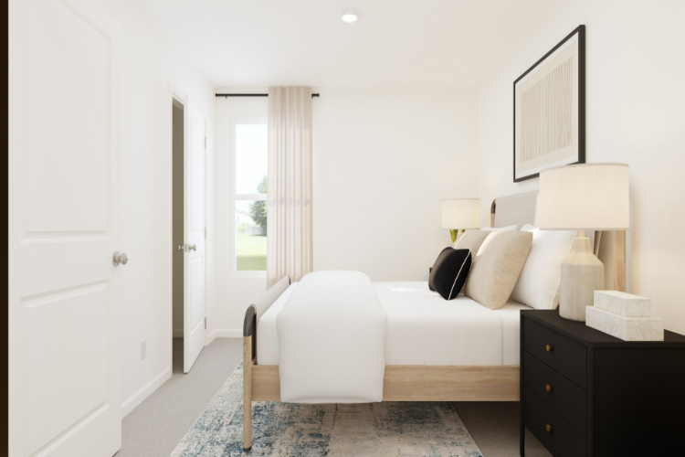 A bedroom with a bed and a lamp.