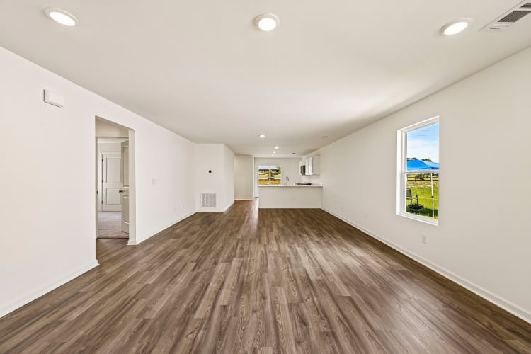 A long hallway with a wood floor.