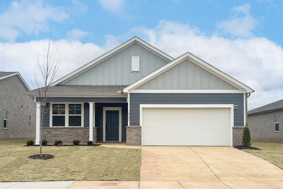 A house with a garage with American Gothic House in the background.