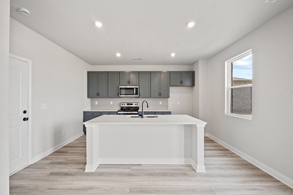 A kitchen with a white counter top.