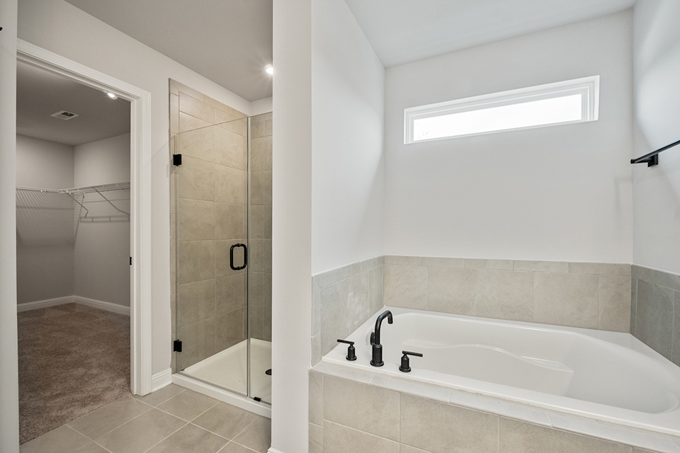 A bathroom with a tub and shower.