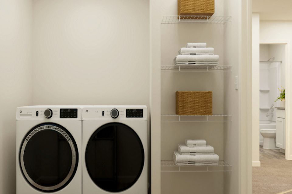 A white laundry room with a white shelf and a white laundry basket.