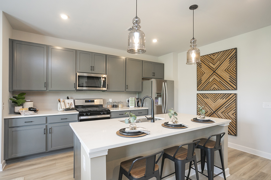 A kitchen with a table and chairs.