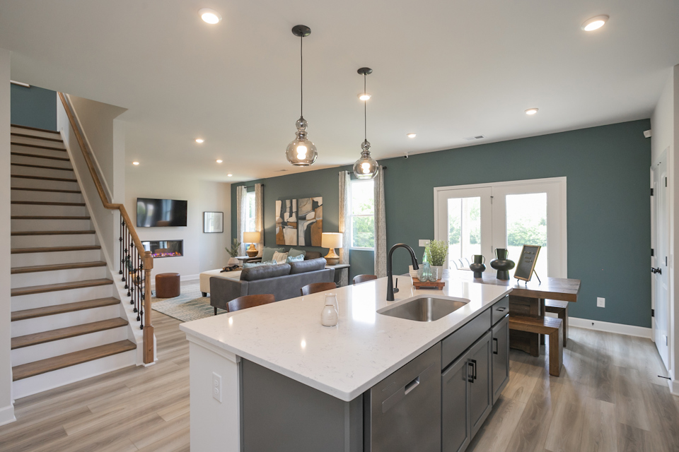 A kitchen with a large staircase.