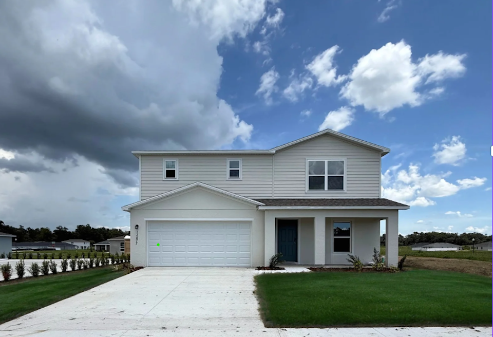 A white house with a driveway.