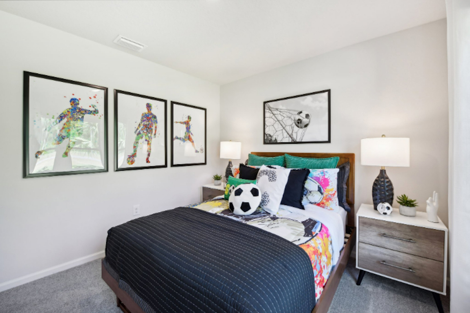 A bedroom with a bed and lamps.