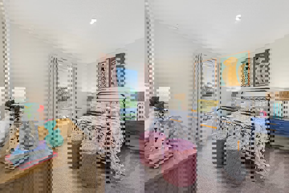 A bedroom with a bed and a desk.