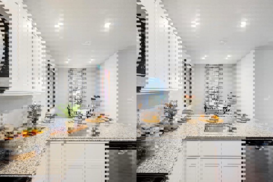 A kitchen with white cabinets.