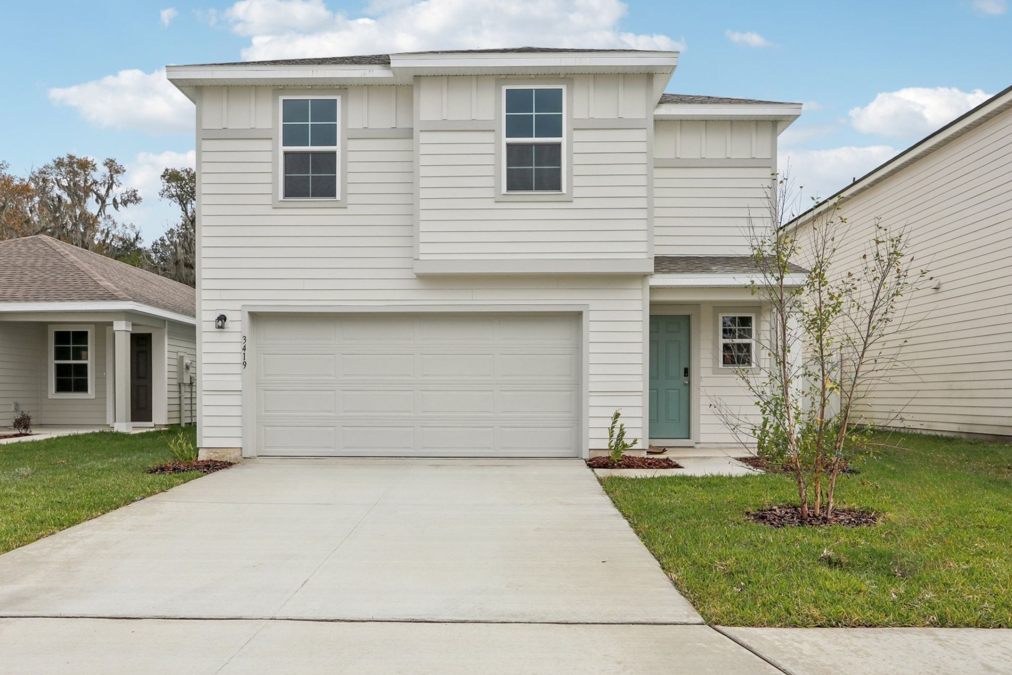 A white house with a garage.