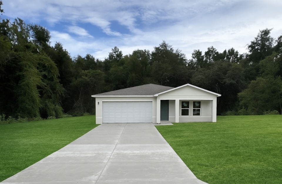 A house with a driveway and grass.