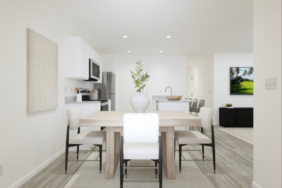 A dining room with a table and chairs.