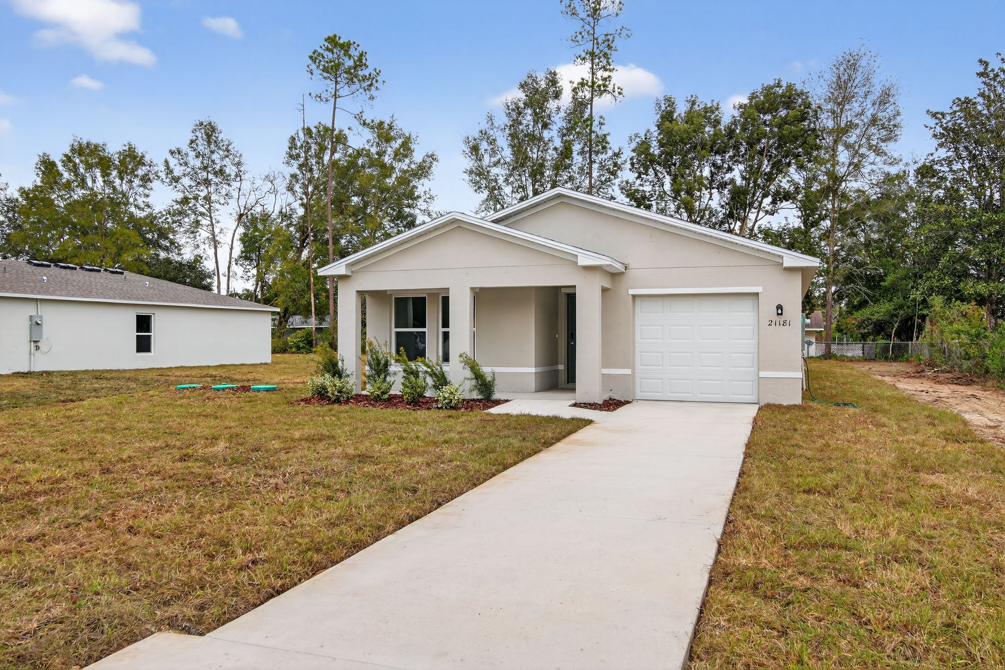 A white garage with a driveway.