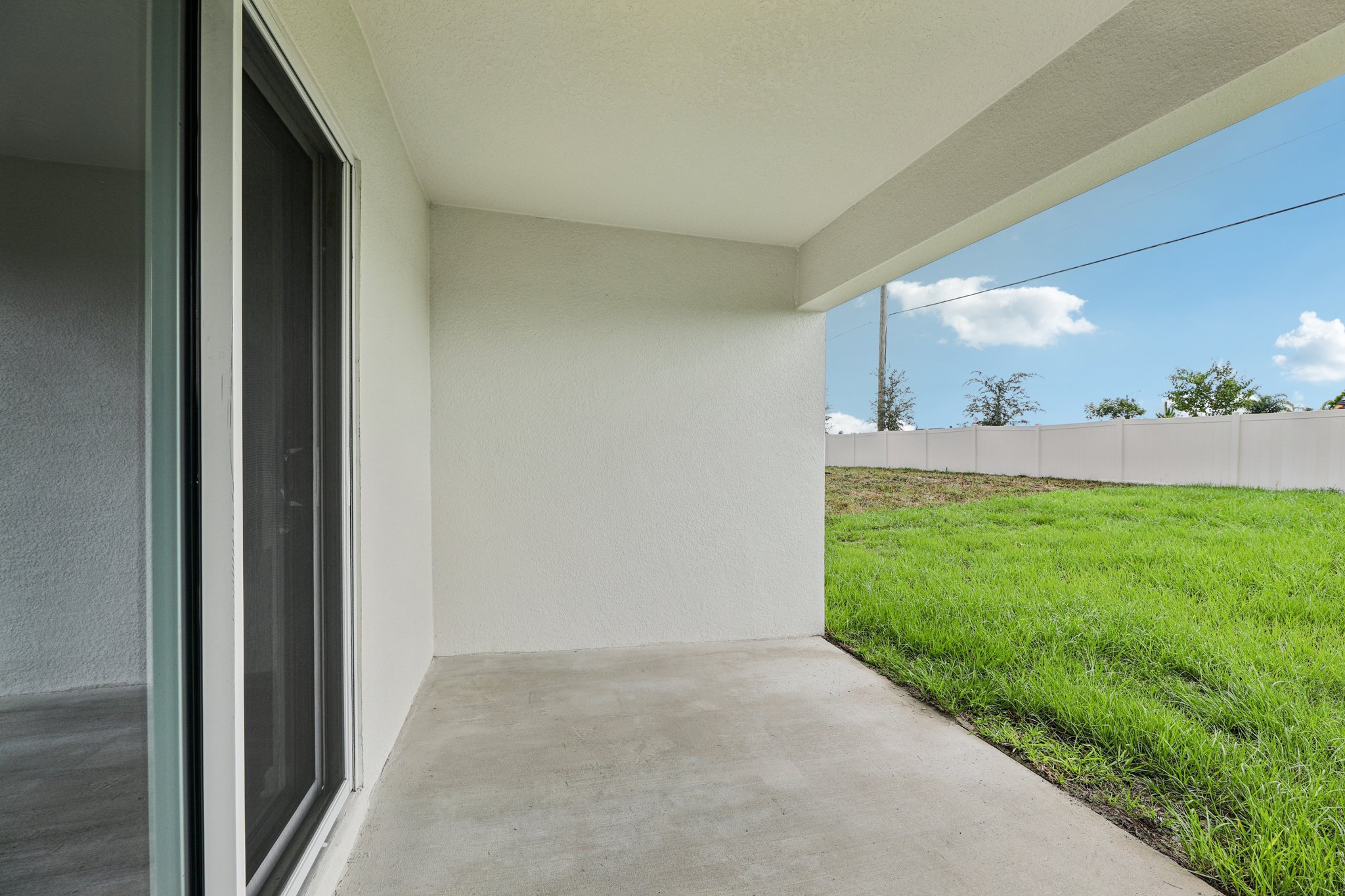 A building with grass and a walkway.