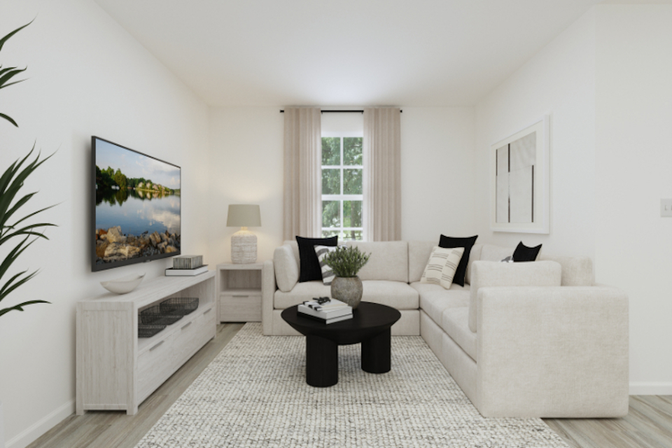 A living room with a white couch and a coffee table.