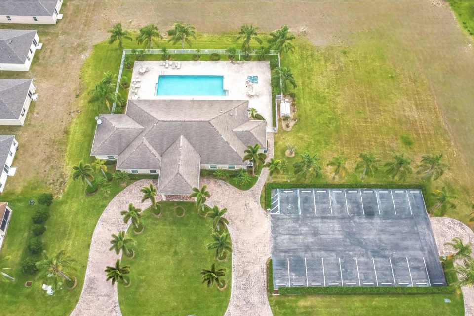 A building with a pool in the middle of a field.