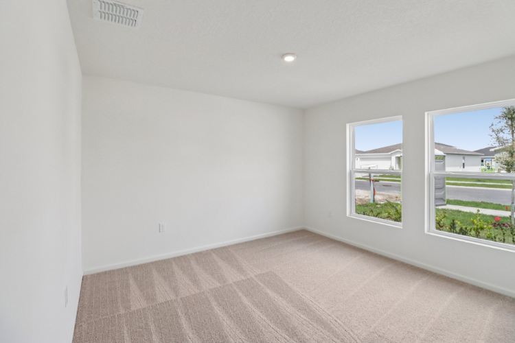 A room with a wood floor and windows.