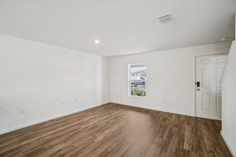 A room with a wood floor and white doors.