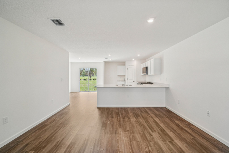 A room with white walls and a wood floor.