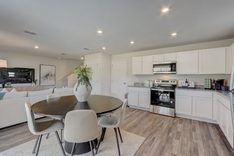 A kitchen with white cabinets.