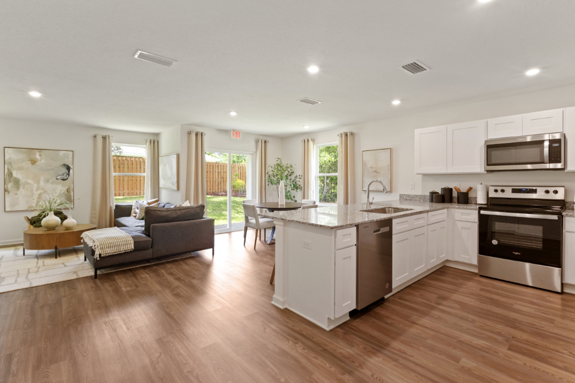 A large kitchen with a wood floor.