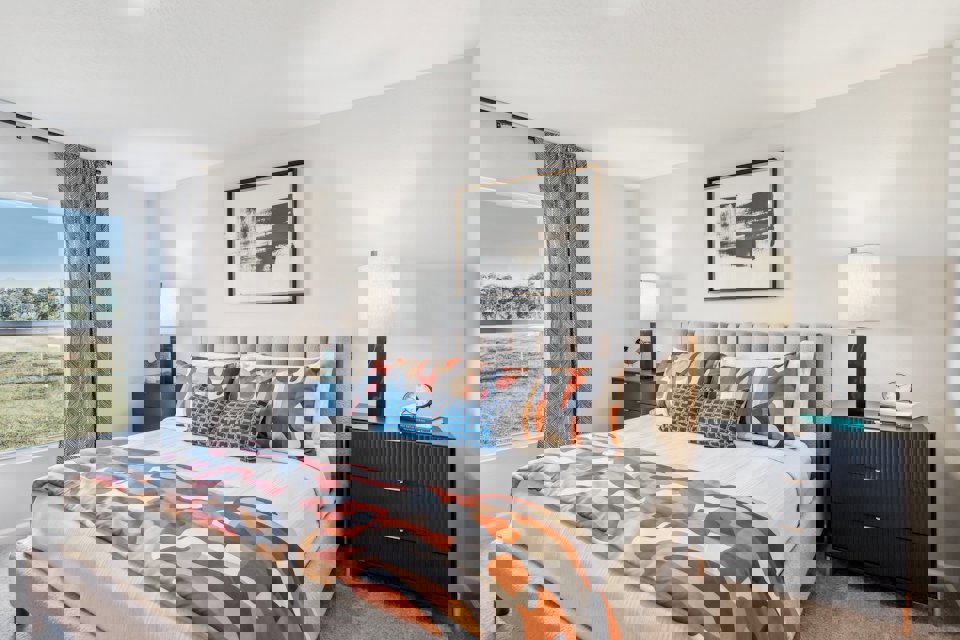 A bed with a colorful blanket.